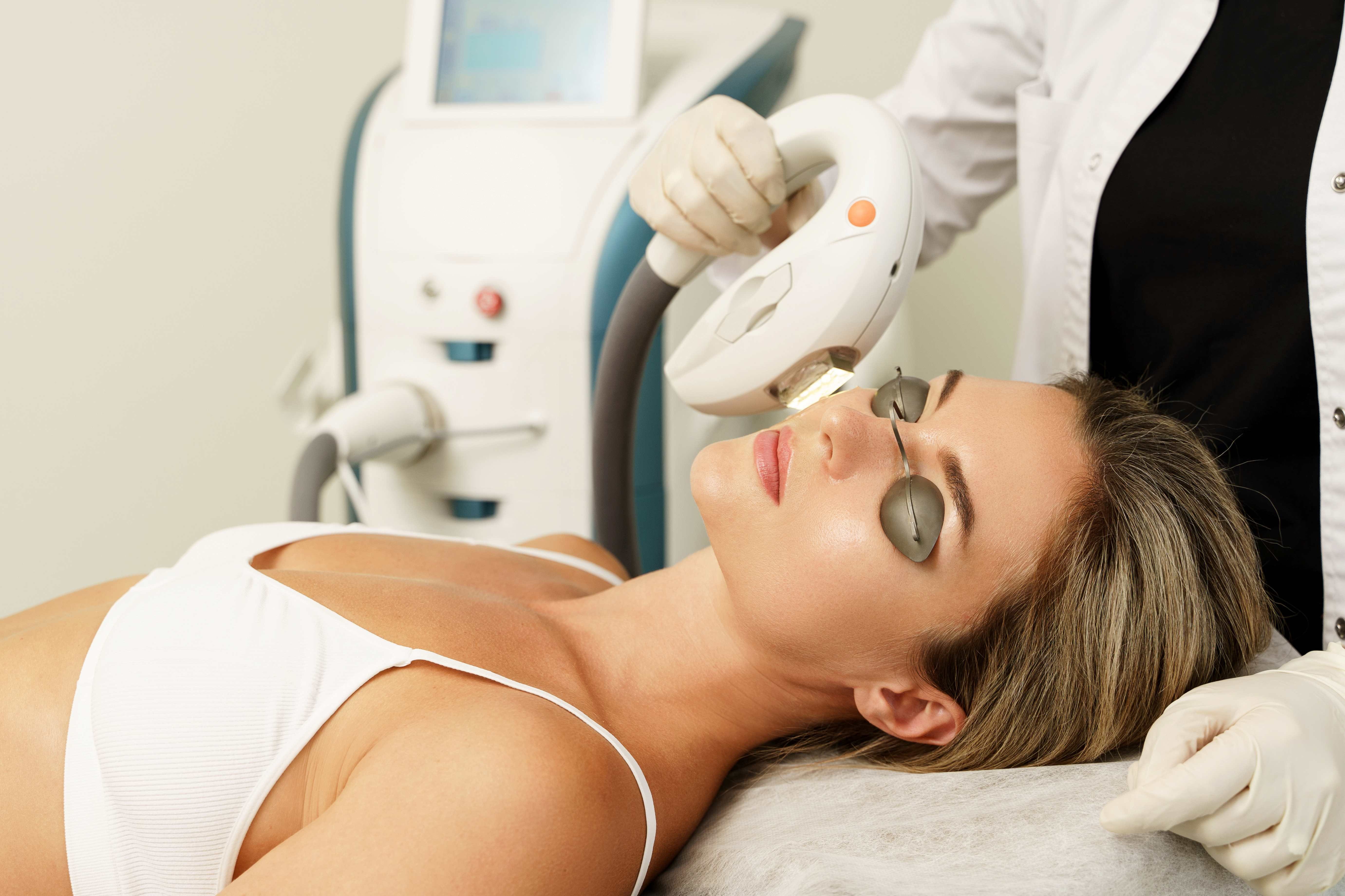 Skincare specialist administering a photorejuvenation treatment at Lougheed Laser Centre.